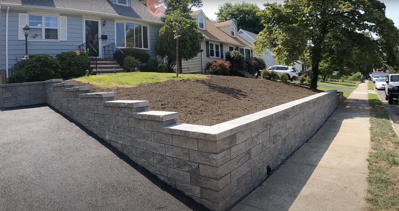 Concrete block retaining wall installed in a residential yard to prevent erosion