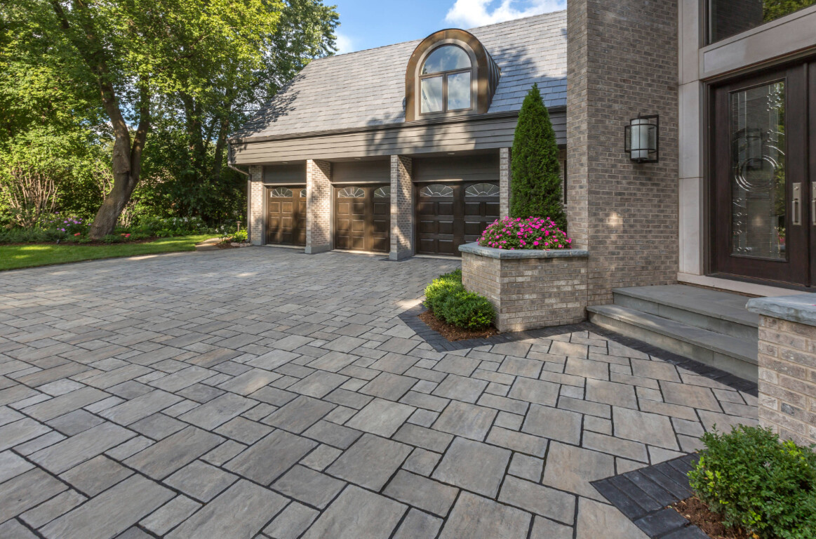 Luxury stamped concrete driveway with stone pattern at an upscale home